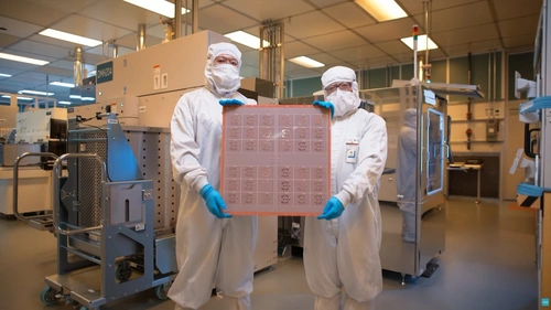 Các kỹ sư giới thiệu một tấm wafer bán dẫn tại phòng sạch của nhà máy. Ảnh: .